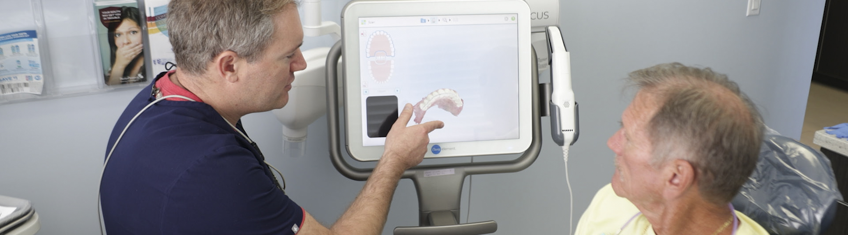 Dentist showing a patient a digital model of dentures in Jupiter