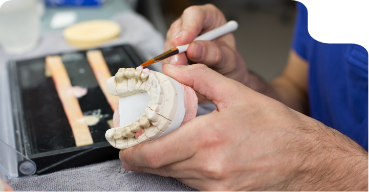 Dental lab technician creating a denture