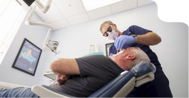 Dentist examining a patients mouth