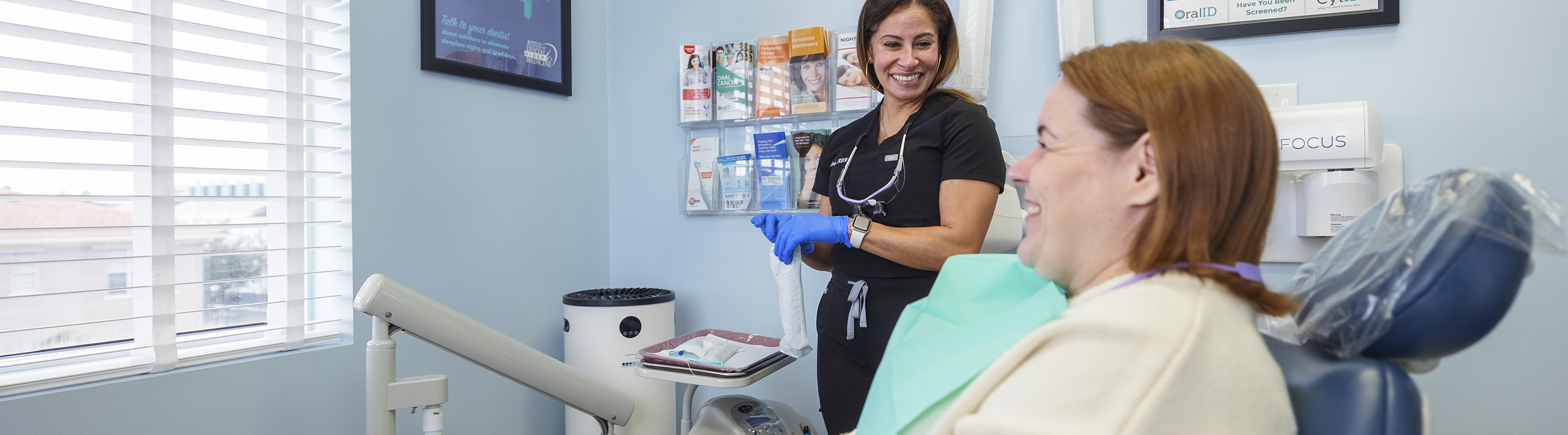 Dental team member smiling at a patient before providing dental implant services in Jupiter