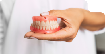 Dentist holding a set of full dentures