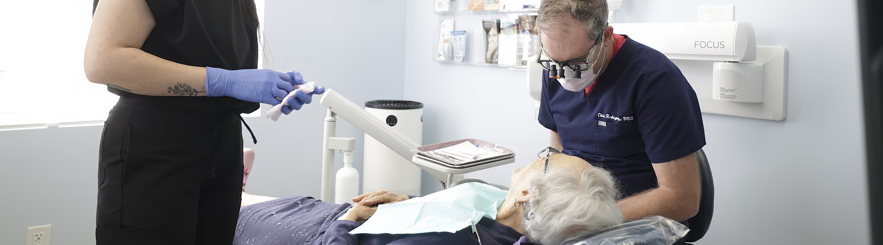 Senior dental patient smiling at their dentist right before treatment